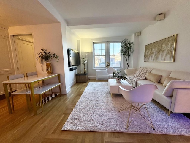 living area with light wood-style floors and baseboards