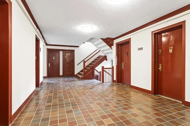 corridor featuring ornamental molding and a textured ceiling