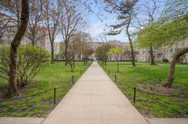 view of property's community with a lawn