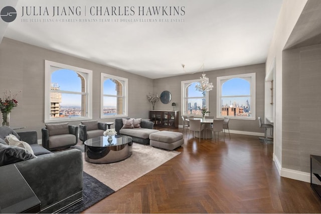 living room with dark parquet flooring and a chandelier