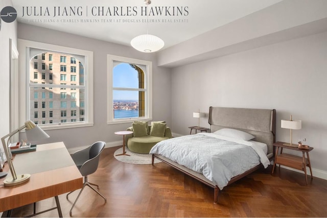 bedroom featuring parquet floors and a water view