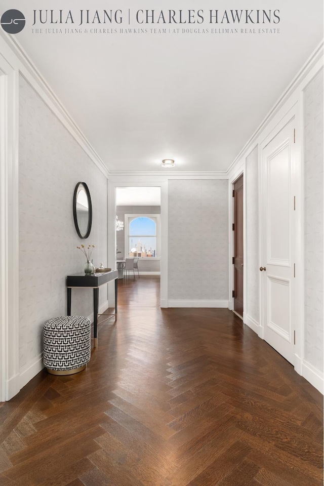 hall with baseboards and ornamental molding