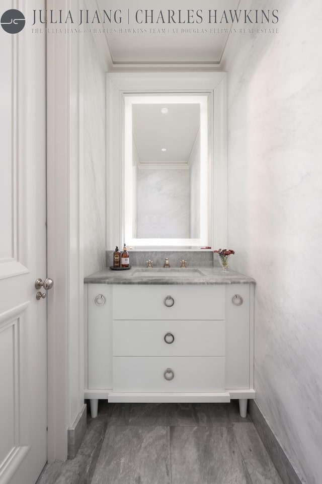 bathroom featuring baseboards and vanity