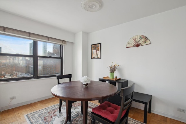 dining space with parquet floors