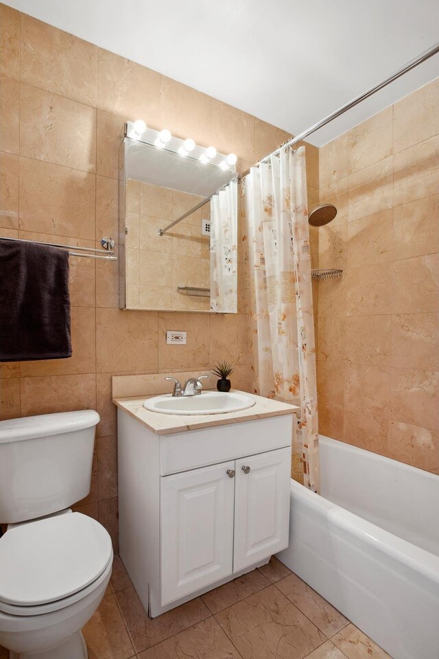 166 E 61st St Unit 9G, New York City, NY 10021 - bathroom featuring shower / tub combo, vanity, tile walls, and toilet