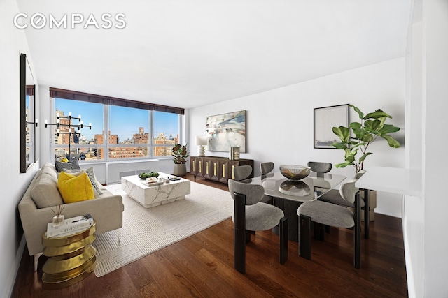 dining area featuring a view of city and wood finished floors