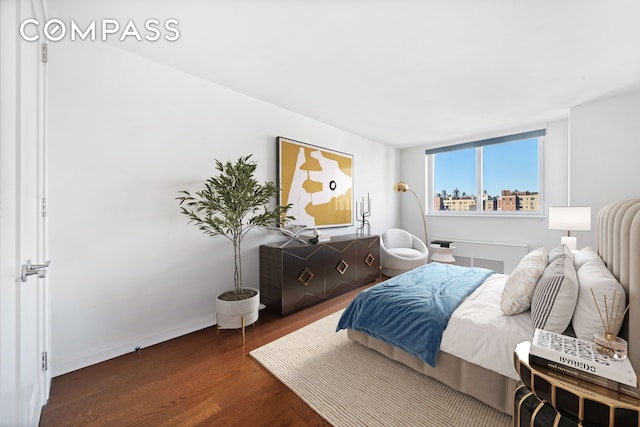 bedroom with wood finished floors and baseboards