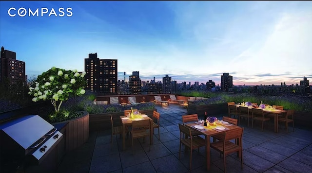 patio terrace at dusk with outdoor dining area and a city view