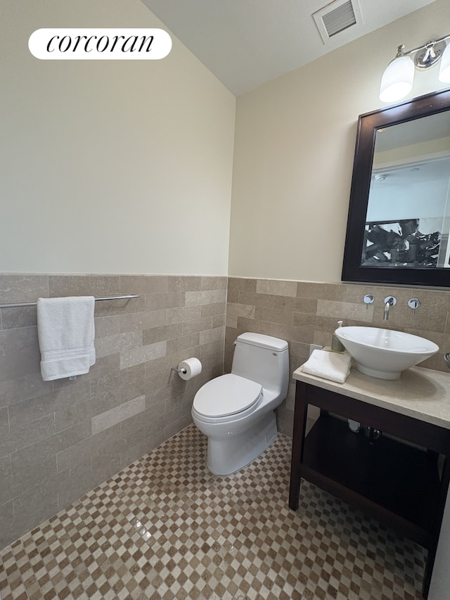640 W 237th St Unit 7B, New York City, NY 10463 - bathroom with tile patterned floors, a wainscoted wall, tile walls, and vanity