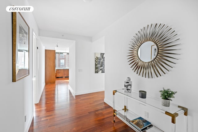 hallway with hardwood / wood-style flooring