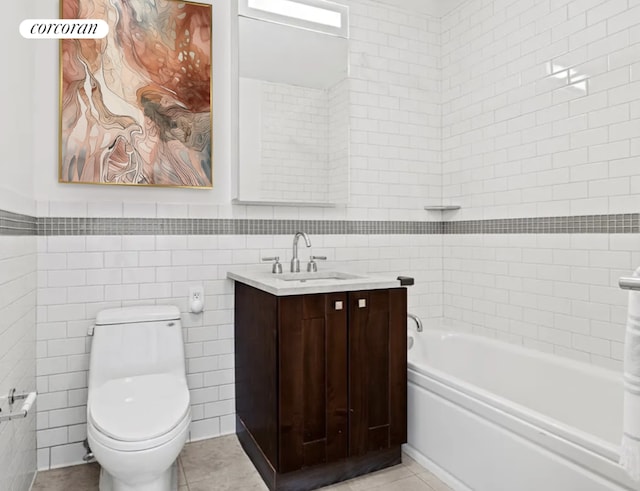 bathroom featuring tile patterned floors, toilet, tile walls, vanity, and a bathing tub