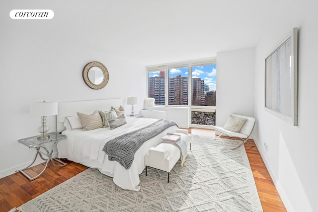 living room with expansive windows and hardwood / wood-style floors