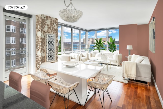 living room with hardwood / wood-style floors and a wall of windows