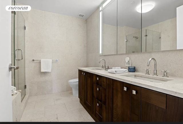 640 W 237th St Unit 7B, New York City, NY 10463 - full bath featuring tile walls, a stall shower, and double vanity