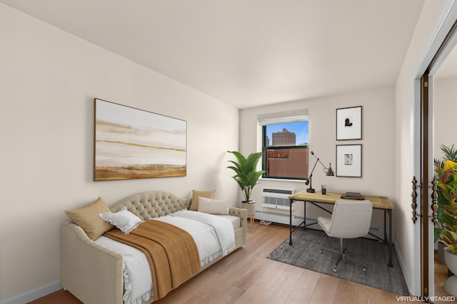 2235 Frederick Douglass Blvd Unit 7K, New York City, NY 10027 - interior space with light wood-type flooring, a wall mounted air conditioner, and baseboards