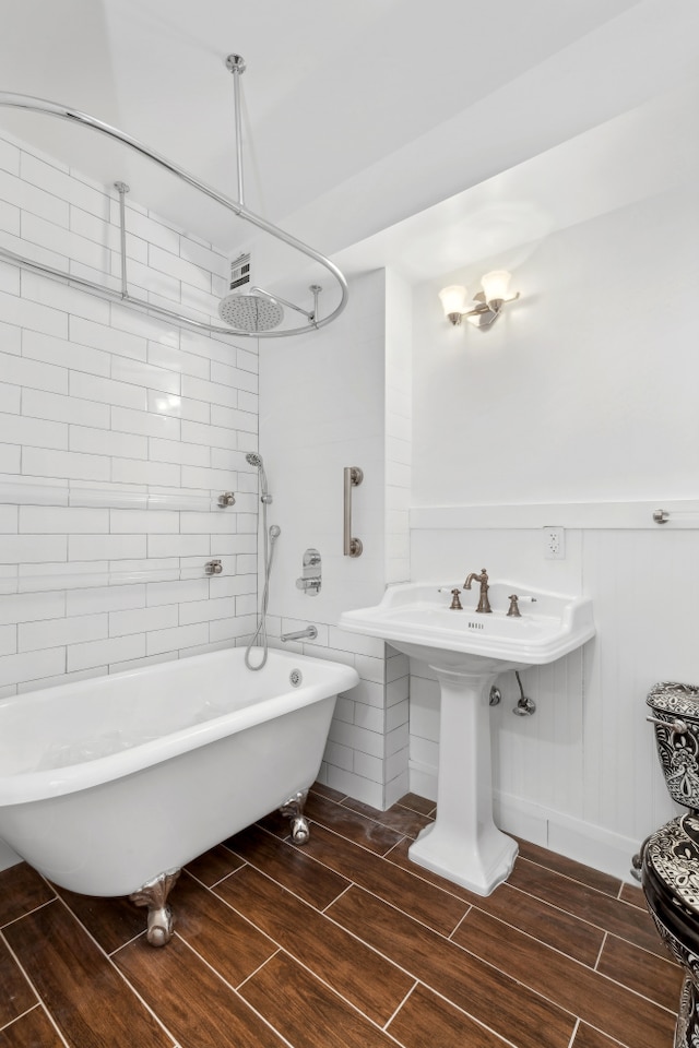 2235 Frederick Douglass Blvd Unit 7K, New York City, NY 10027 - full bath featuring wood finish floors and a combined bath / shower with freestanding tub