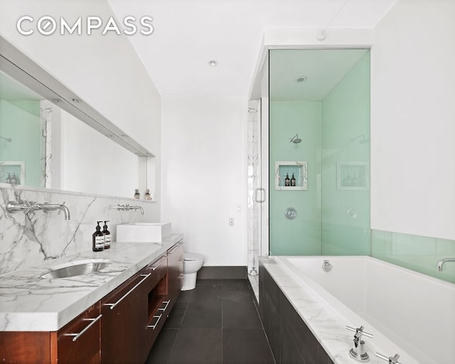 full bathroom with tile patterned flooring, vanity, plus walk in shower, decorative backsplash, and toilet