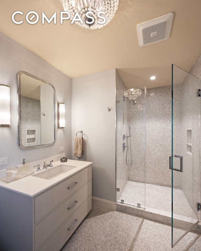 full bath featuring visible vents, baseboards, vanity, and a shower stall