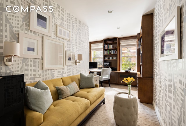 living area with wallpapered walls, recessed lighting, and baseboards