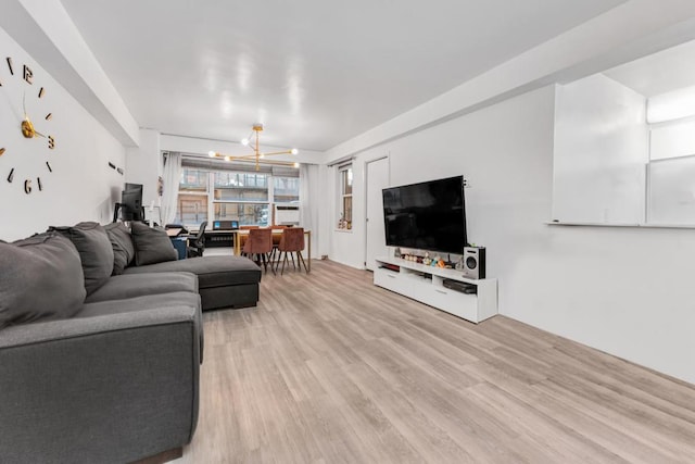 living room with hardwood / wood-style floors and a notable chandelier