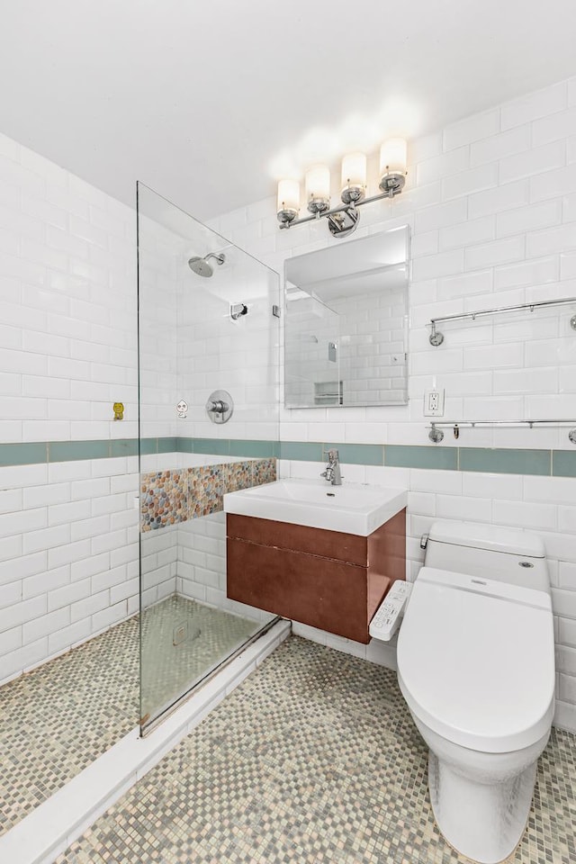 bathroom featuring vanity, walk in shower, toilet, and tile walls