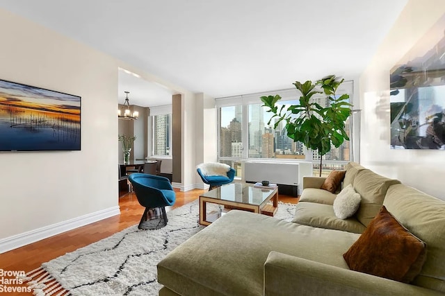 living room featuring hardwood / wood-style flooring and a chandelier