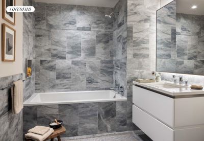 bathroom with tiled shower / bath, vanity, and tile walls