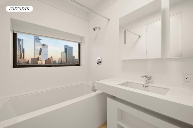 full bath with visible vents, a sink, a washtub, and a city view