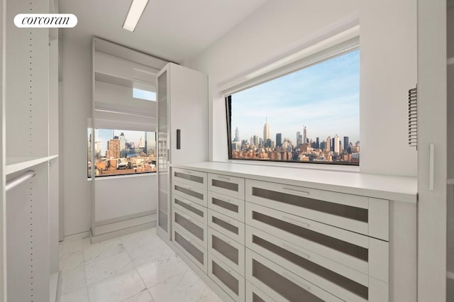 interior space with a view of city and marble finish floor