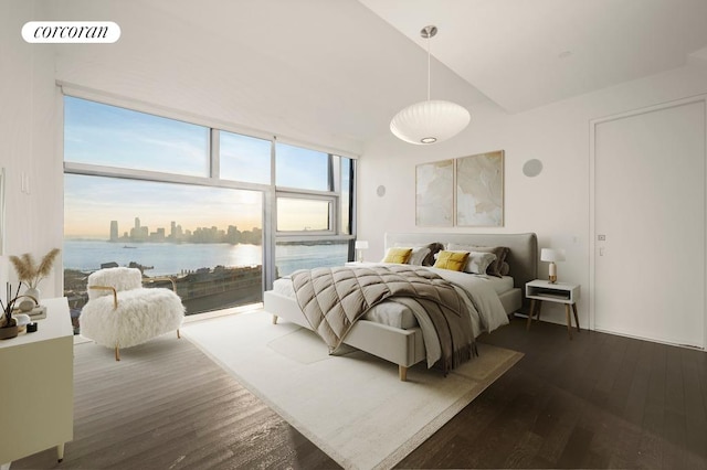 bedroom with hardwood / wood-style floors, high vaulted ceiling, and a water view