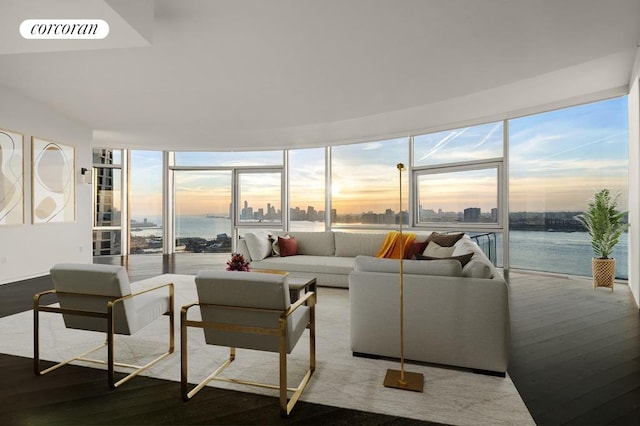 living area featuring expansive windows, visible vents, a city view, and wood finished floors