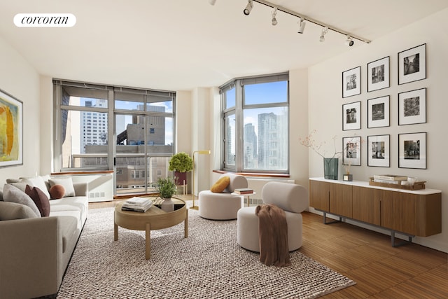 interior space with expansive windows, track lighting, and a healthy amount of sunlight