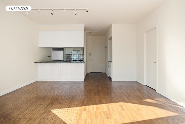 unfurnished living room featuring dark hardwood / wood-style floors