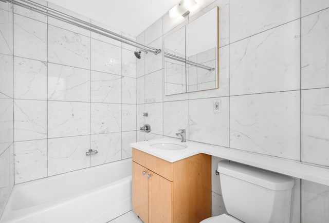 full bathroom with toilet, tiled shower / bath, tile walls, vanity, and decorative backsplash