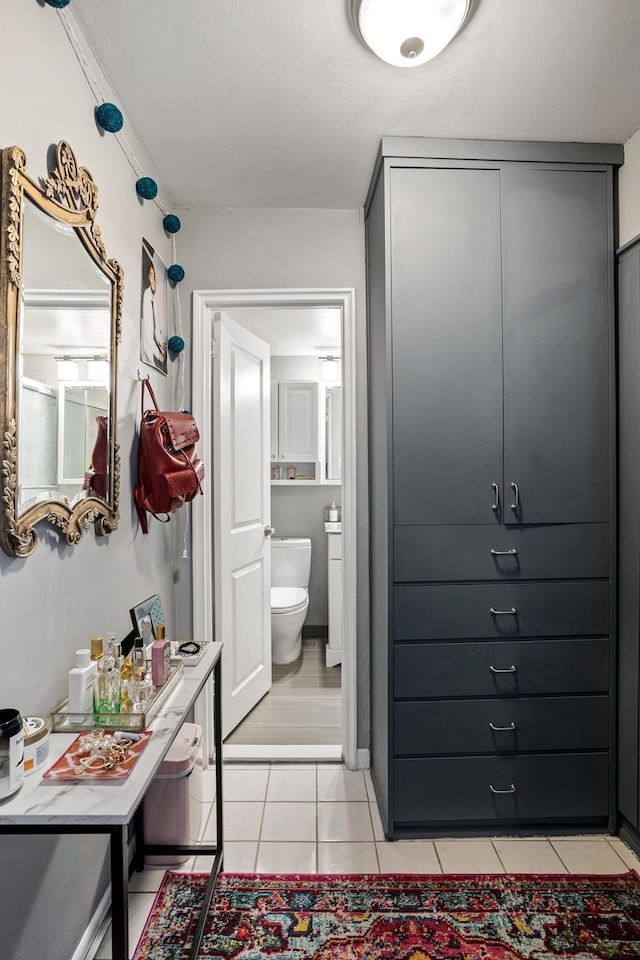 bathroom featuring tile patterned flooring and toilet