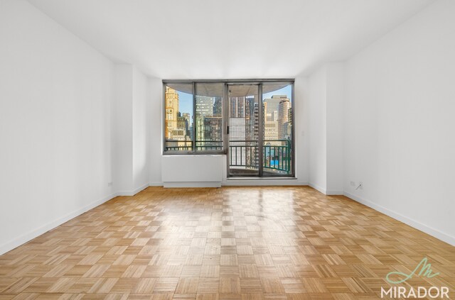 spare room with light parquet flooring