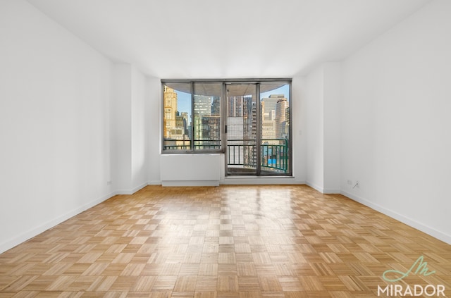 spare room featuring a city view and baseboards