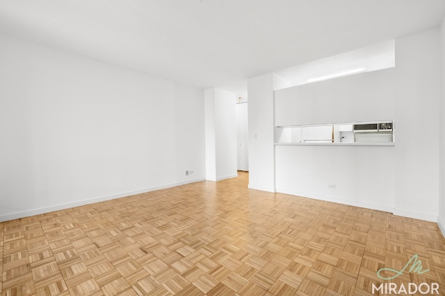 unfurnished living room with light parquet flooring