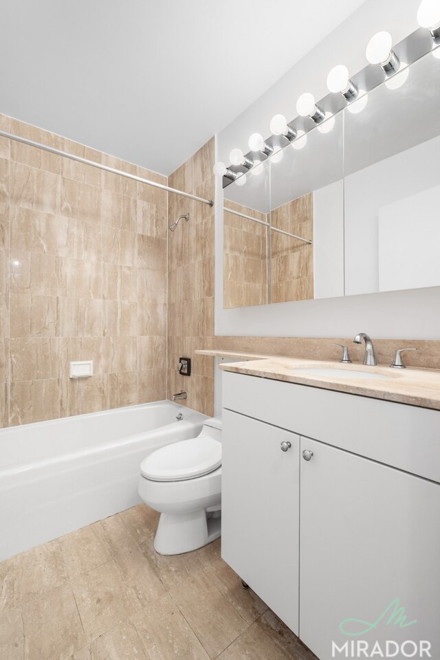 full bathroom with vanity, wood-type flooring, toilet, and tiled shower / bath