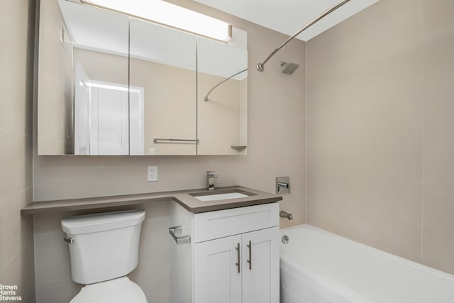 bathroom featuring toilet, vanity, and  shower combination