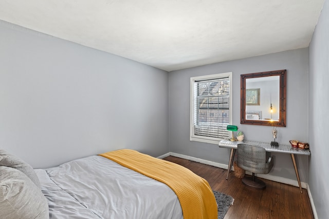 bedroom with wood finished floors and baseboards