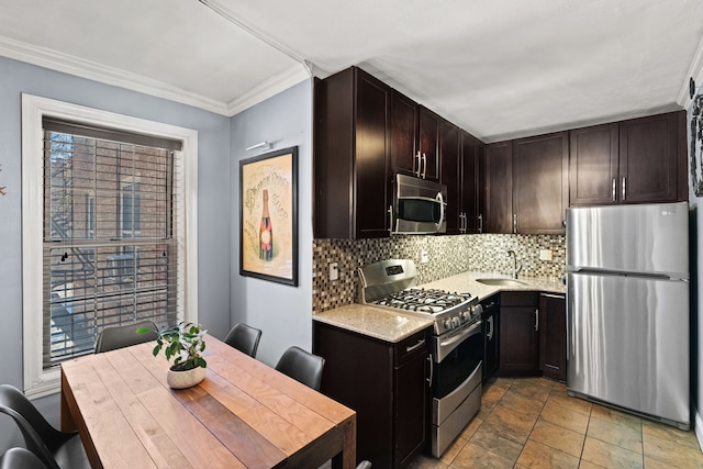 kitchen with a sink, dark brown cabinets, ornamental molding, appliances with stainless steel finishes, and tasteful backsplash