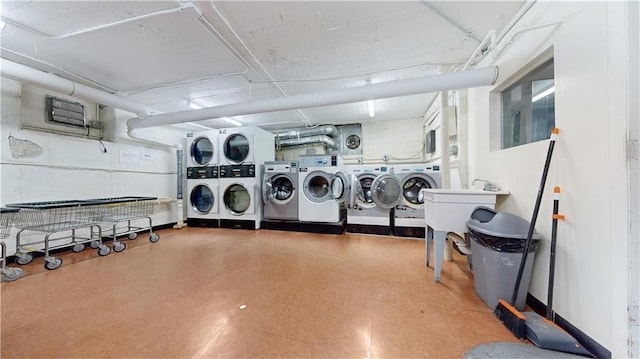 common laundry area with washer and dryer, stacked washer and clothes dryer, and tile patterned floors