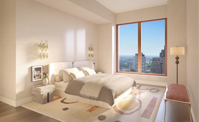 bedroom with a city view, wood finished floors, and baseboards