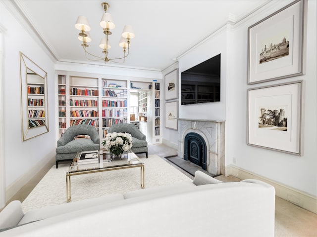 carpeted living room featuring a premium fireplace, crown molding, a chandelier, and built in shelves