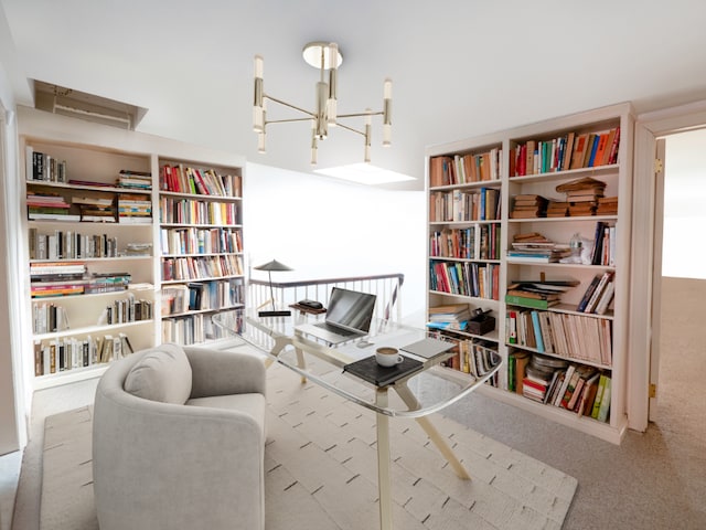 sitting room featuring an inviting chandelier and light colored carpet