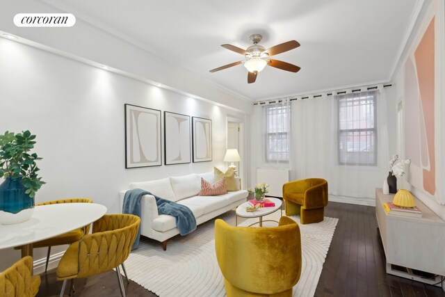 living room featuring ornamental molding, visible vents, a ceiling fan, and dark wood-style floors