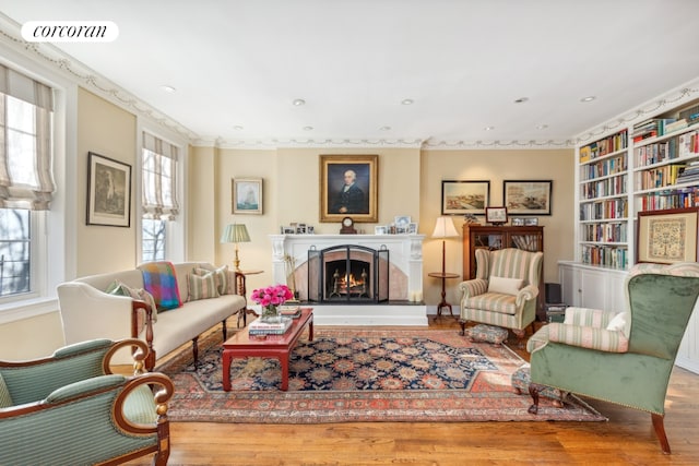 living area featuring hardwood / wood-style floors and built in shelves