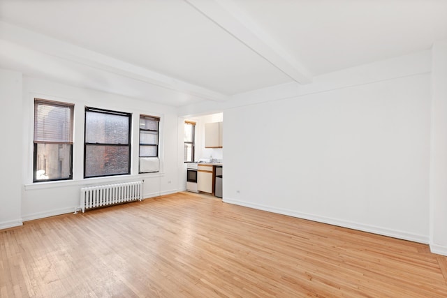 unfurnished living room featuring beamed ceiling, light wood-type flooring, radiator heating unit, and baseboards