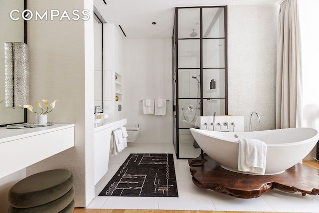 full bathroom with tile patterned flooring, vanity, independent shower and bath, and toilet